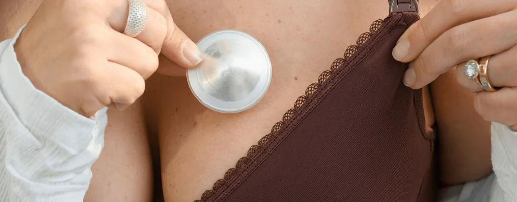 woman wearing silver nipple cup