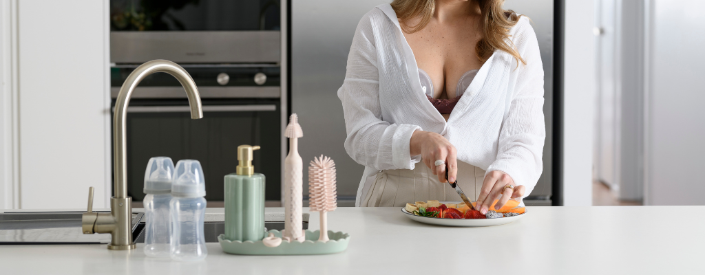 woman cutting fruit on kitchen bench