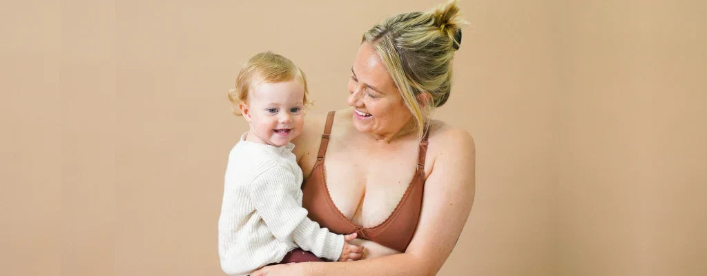 breastfeeding mother holding child
