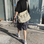 Sac messager en toile de couleur unie
